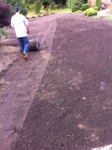 Rolling out the topdressing.